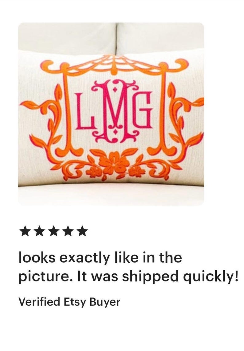 May include: A white pillow with an orange and pink monogram design. The monogram is "LMG" in a decorative font. The pillow has a floral design around the monogram.