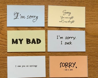 Peut inclure: Neuf cartes colorées avec différentes phrases d'excuses écrites dessus. Les phrases incluent "Je suis désolé", "C'est de ma faute", "Je te dois des excuses", "Désolé, j'étais un imbécile", "On recommence", "J'ai merdé", "Oups ! Je ne voulais vraiment pas dire ça", et "Je suis désolé" avec une liste de raisons pour les excuses.