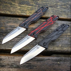 May include: Three pocket knives with different colored handles. The first knife has a black handle with red lines, the second knife has a red handle with black lines, and the third knife has a black handle with gray lines.