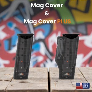 May include: Two black Mag Covers and Mag Cover PLUS are displayed on a wooden surface. The covers have a rectangular shape with a textured design and a black top. The text "Mag Cover & Mag Cover PLUS" is at the top. The American flag and "MADE IN USA" are in the bottom right corner.