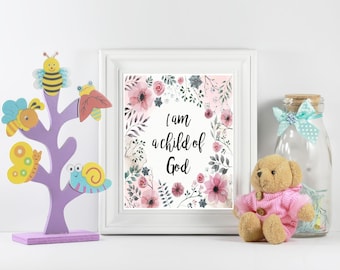 May include: A framed print with the text "I am a child of God" surrounded by floral art. A wooden tree with colorful insect cutouts, a teddy bear in a pink sweater, and a glass jar with a bow are also present.