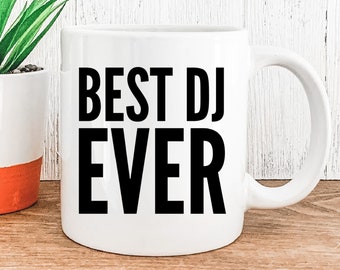 May include: White ceramic coffee mug with a black inscription that reads "BEST DJ EVER".