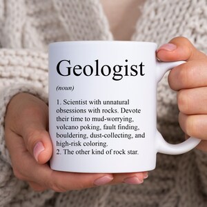 May include: White ceramic mug with the word "Geologist" printed in black, along with a definition. The definition describes a geologist's interests in rocks, volcanoes, and other geological activities. A perfect gift for a geologist.