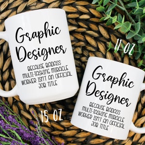 May include: Two white ceramic mugs with black text. The larger mug is 15 oz and the smaller mug is 11 oz. Both mugs say "Graphic Designer" and "Because badass multi-tasking miracle worker isn't an official job title."
