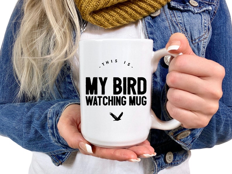May include: White ceramic mug with a black design that says "This is my bird watching mug" with a black silhouette of a bird underneath the text.