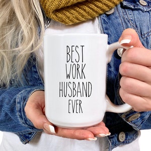 May include: White ceramic mug with black text that reads "Best Work Husband Ever".