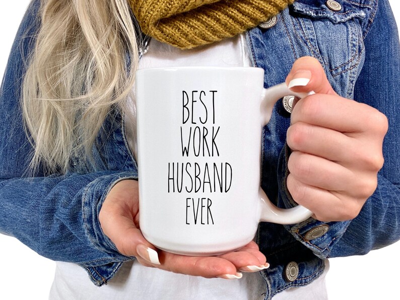 May include: White ceramic mug with black text that reads "Best Work Husband Ever".