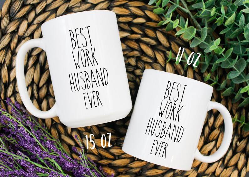 May include: Two white ceramic mugs with black text that reads "Best Work Husband Ever". The larger mug is 15 oz and the smaller mug is 11 oz.