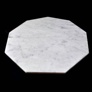 May include: White marble octagonal serving tray with a smooth surface and subtle gray veining.