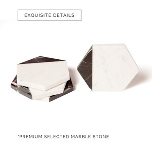 May include: Set of four black and white marble hexagon coasters.  "EXQUISITE DETAILS" and "PREMIUM SELECTED MARBLE STONE" are printed on the white background.
