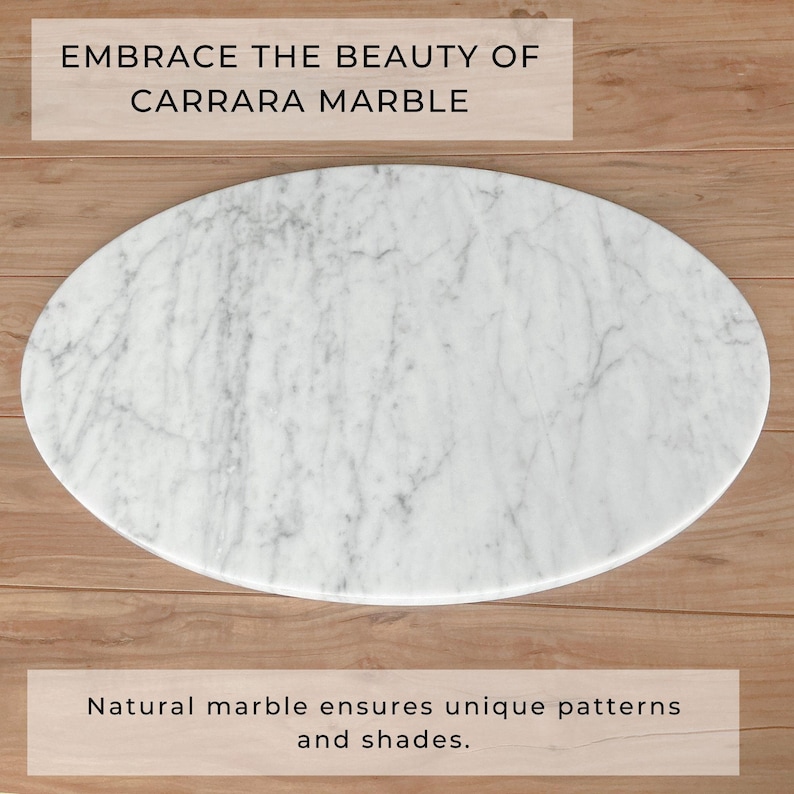 May include: Oval Carrara marble slab with gray veining. The text "EMBRACE THE BEAUTY OF CARRARA MARBLE" is at the top. The text "Natural marble ensures unique patterns and shades" is at the bottom. The marble is on a wooden surface.
