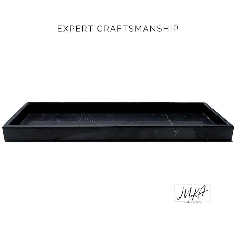 This black marble tray showcases expert craftsmanship with its polished finish and smooth edges. The natural white veining adds a luxurious touch, making it perfect for serving, organizing, or decorating.