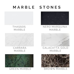 Image shows six marble swatches labeled: Thassos (white), Nero Marquina (black), Carrara (grey with veining), Calacatta Gold (white with grey veining), Green Marble, and Brown Marble.