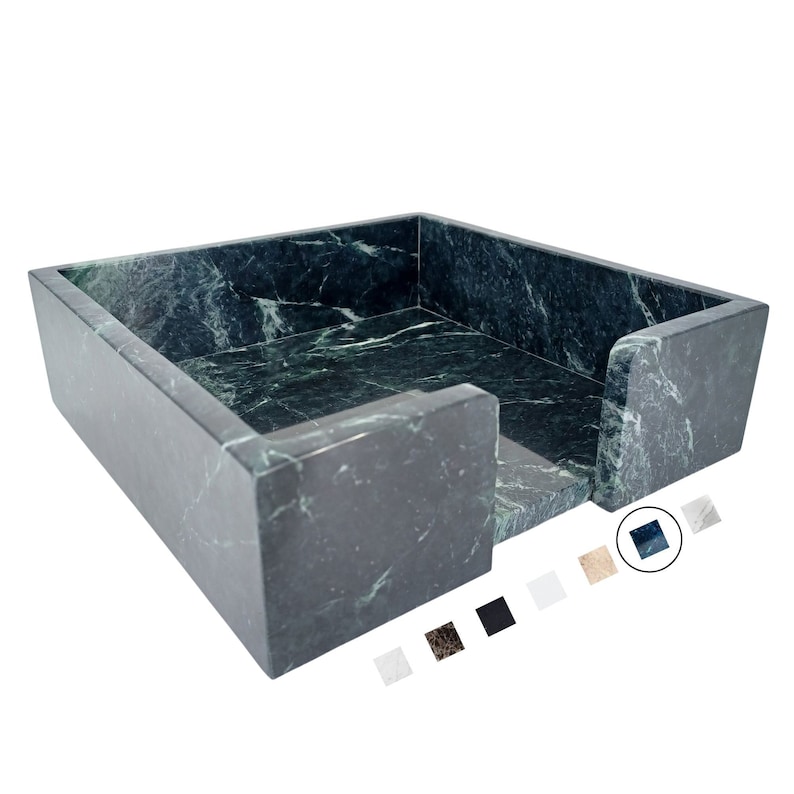 A green marble napkin holder with light veining. Below are swatches of marble options: Thassos (white), Nero Marquina (black), Carrara (grey with veining), Calacatta Gold (white with grey veining), Green, Brown, and beige marble.