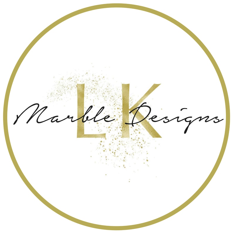 May include: A gold circle with a gold "LK" logo and the text "Marble Designs" in black cursive script. The logo is surrounded by a gold glitter effect.