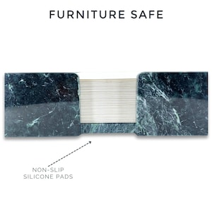 May include: A dark green marble desk accessory with a polished finish and a central stack of thin, light-colored paper sheets. The text FURNITURE SAFE appears at the top, and an arrow points to the base labeled NON-SLIP SILICONE PADS.