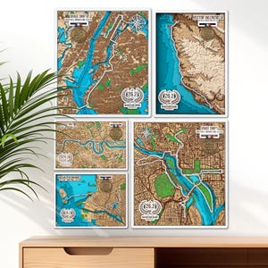May include: A collection of framed wooden maps with a layered design, showcasing cityscapes and coastlines. Each map features a marathon theme, with the number "26.2" and the words "Marathon Name" visible. Some maps include names and the text "Your Medal Here".