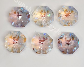 May include: Six iridescent, octagonal crystals with multiple facets. The crystals have a clear, shimmering appearance with hints of pink, yellow, and blue. The crystals are arranged in two rows of three on a white surface.