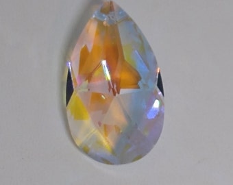 May include: A clear iridescent teardrop-shaped crystal prism with a faceted design. The prism has a rainbow effect.