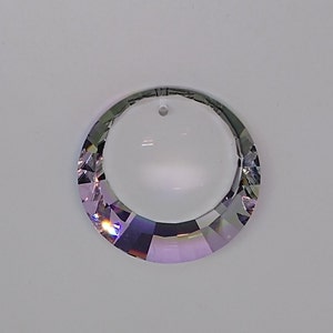 May include: A clear crystal prism with a round hole in the center. The prism has a rainbow iridescent finish.