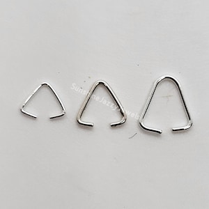May include: Three silver triangle jump rings of different sizes. The jump rings are open and ready to be used for jewelry making.