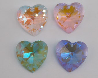 May include: Four heart-shaped crystal pendants in different colours: pink, blue, green, and a light pink with orange hues. The crystals are faceted and have a rainbow iridescent effect.