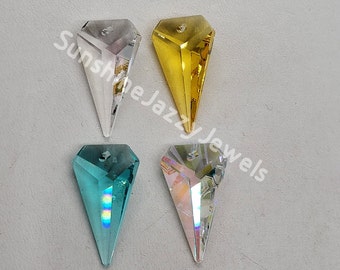 May include: Four crystal teardrop pendants in different colors: clear, gold, light blue, and iridescent. The pendants are faceted and have a pointed tip.