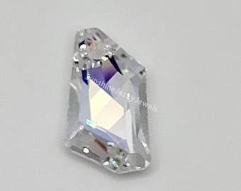 May include: A clear, faceted gemstone with an irregular shape. The gem has multiple facets that reflect light, creating a sparkling effect. The text "Sunshine Jazzy Jewels" is visible on the gem.