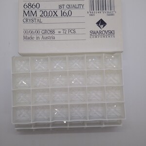 May include: A package of 72 clear crystal rhinestones, labeled "6860 MM 20,0X 16,0 CRYSTAL 1ST QUALITY 00/06/00 GROSS = 72 PCS. Made in Austria SWAROVSKI COMPONENTS".