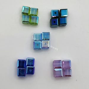 May include: A white ceramic mug with a black handle and the text "But First, Coffee" in a black, handwritten-style font. The mug is on a white surface.