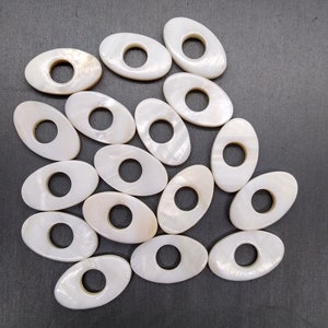 50 perline in madreperla MOP; perline ovali piatte bianche/crema da 25 mm con ciambella centrale aperta; a forma di occhio