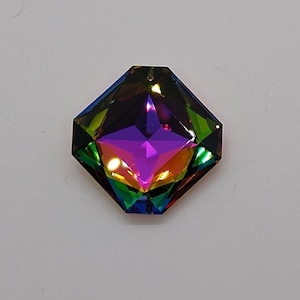 May include: A multi-faceted iridescent gemstone with a purple center and a rainbow of colors around the edges. The gemstone is shaped like a hexagon with rounded corners.