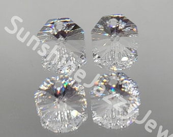 May include: Four clear crystal octagon shaped pendants with a hole at the top for hanging. The crystals have a faceted design and a frosted finish.
