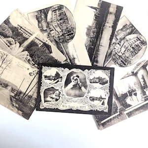 Puede incluir: Una colección de postales antiguas en blanco y negro con escenas arquitectónicas y paisajísticas. Las postales muestran edificios, fuentes y un retrato con el texto "Mille Baisers de METZ". Las postales están dispuestas sobre una superficie blanca.