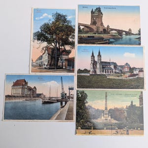 May include: A collection of five vintage postcards featuring scenes from Worms, Germany. The postcards depict various landmarks, including a bridge, cathedral, and monument, with detailed illustrations and vibrant colors. The postcards are in good condition, showing signs of age.