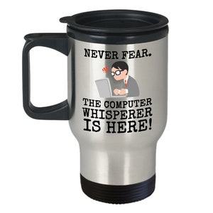 May include: A silver travel mug with a black handle and lid. The mug has a black graphic of a person working on a computer with the text "NEVER FEAR. THE COMPUTER WHISPERER IS HERE!"