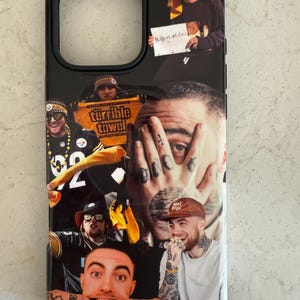 May include: Black iPhone case featuring a collage of images. The design includes multiple portraits of a person, with tattoos and various expressions. The case has a black border and a cutout for the camera.