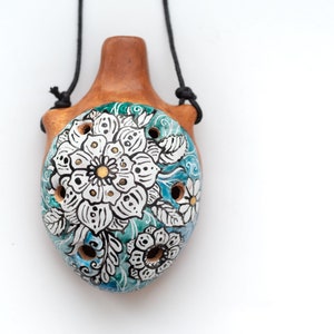 Ceramic ocarina with floral doodling. Small handcrafted musical pendant with black and white painting