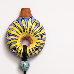Ceramic ocarina solar pendant. Small hand painted clay whistle. Ocarina necklace