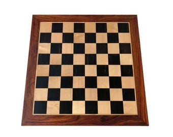May include: A wooden chessboard with a dark brown frame and black and light wood squares.