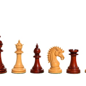 May include: A set of wooden chess pieces, including a king, queen, knight, bishop, rook, and pawn. The pieces are made of dark red and light brown wood.