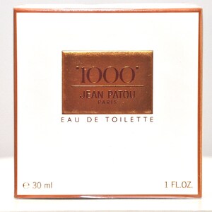 May include: A white box with a gold and red label that says "1000" Jean Patou Paris Eau de Toilette. The box is 1 fl oz or 30 ml.