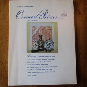 May include: Book cover for "Oriental Primer" by Robert W. Miller. The cover features a colorful illustration of a vase and a plate on a stand. The text "Featuring The Corning Boom in the Orient" is printed below the illustration.