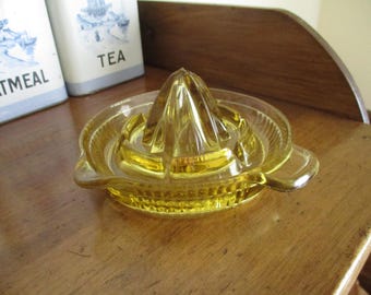 Yellow depression glass juicer or reamer,  small chip under handle