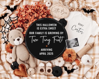 May include: A Halloween-themed baby announcement with a black chalkboard sign that reads "This Halloween is extra sweet, our family is growing by two tiny feet! Arriving April 2025". The sign is surrounded by a teddy bear, a baby onesie, a pumpkin, a wooden pumpkin sign that reads "Little Boo", and a sonogram image.