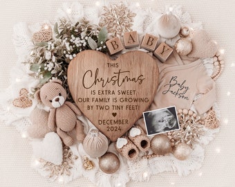 May include: A wooden heart-shaped sign with the text "This Christmas is extra sweet our family is growing by two tiny feet! December 2024". The sign is surrounded by a variety of baby-themed items, including a teddy bear, a onesie, and a sonogram photo.