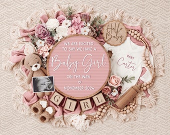 May include: A pink and cream-colored baby announcement with a wooden sign that reads "We are excited to say we have a Baby Girl on the way! November 2024." Includes a teddy bear, baby clothes, and wooden blocks spelling "GIRL."