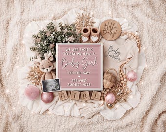 May include: A pink and white letter board with the text "We are excited to say we have a Baby Girl on the way! Arriving August 2025".  The letter board is surrounded by a variety of baby-themed decorations, including a wooden sign that says "Hello Baby!" and a small stuffed reindeer.