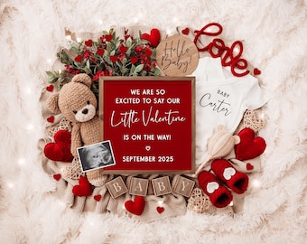 May include: A red letter board with the text "We are so excited to say our Little Valentine is on the way! ♡ September 2025". A white onesie with the text "Baby Carter" is next to the letter board. There are red hearts, a teddy bear, and a baby ultrasound image in the photo.