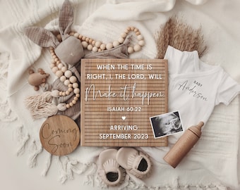 May include: A wooden sign with the text "WHEN THE TIME IS RIGHT, I, THE LORD, WILL Make it happen ISAIAH 60:22" and "ARRIVING SEPTEMBER 2023". There is a small wooden sign that says "Coming Soon" and a white onesie with the text "BABY Anderson".